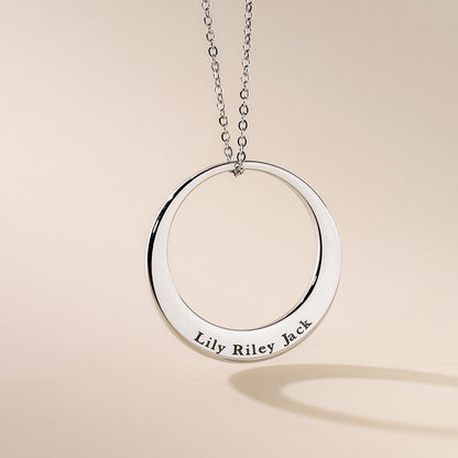 A silver personalised washer necklace with a round pendant featuring the engraved text 'Lily Riley Jack' on a chain.