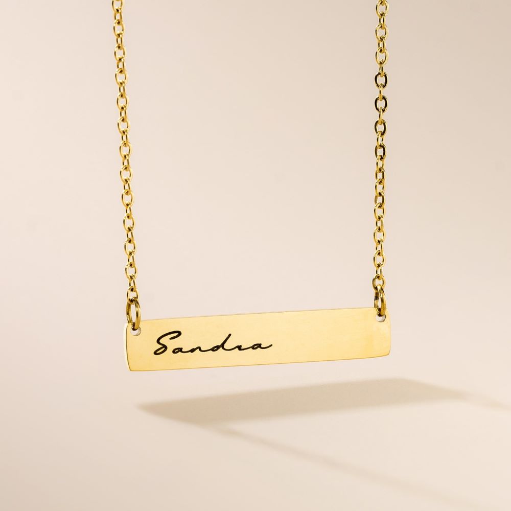 A golden engraved pendant necklace