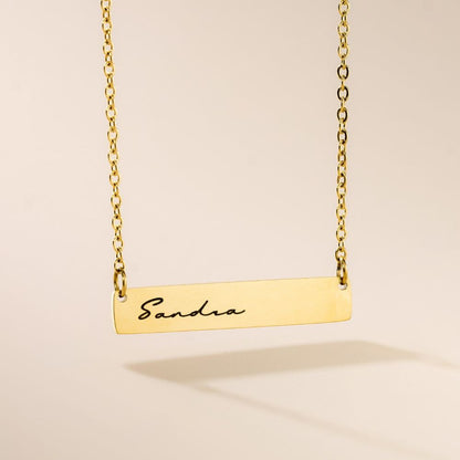 A golden engraved pendant necklace