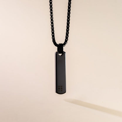A sleek black pendant necklace with a box chain displayed against a neutral background.