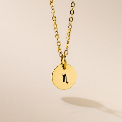 A gold-plated Scorpio zodiac pendant necklace on a gold-plated chain, displayed against a neutral background.