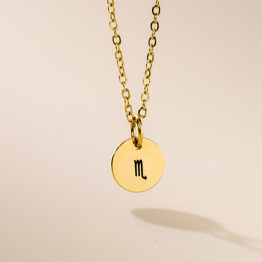 A gold-plated Scorpio zodiac pendant necklace on a gold-plated chain, displayed against a neutral background.