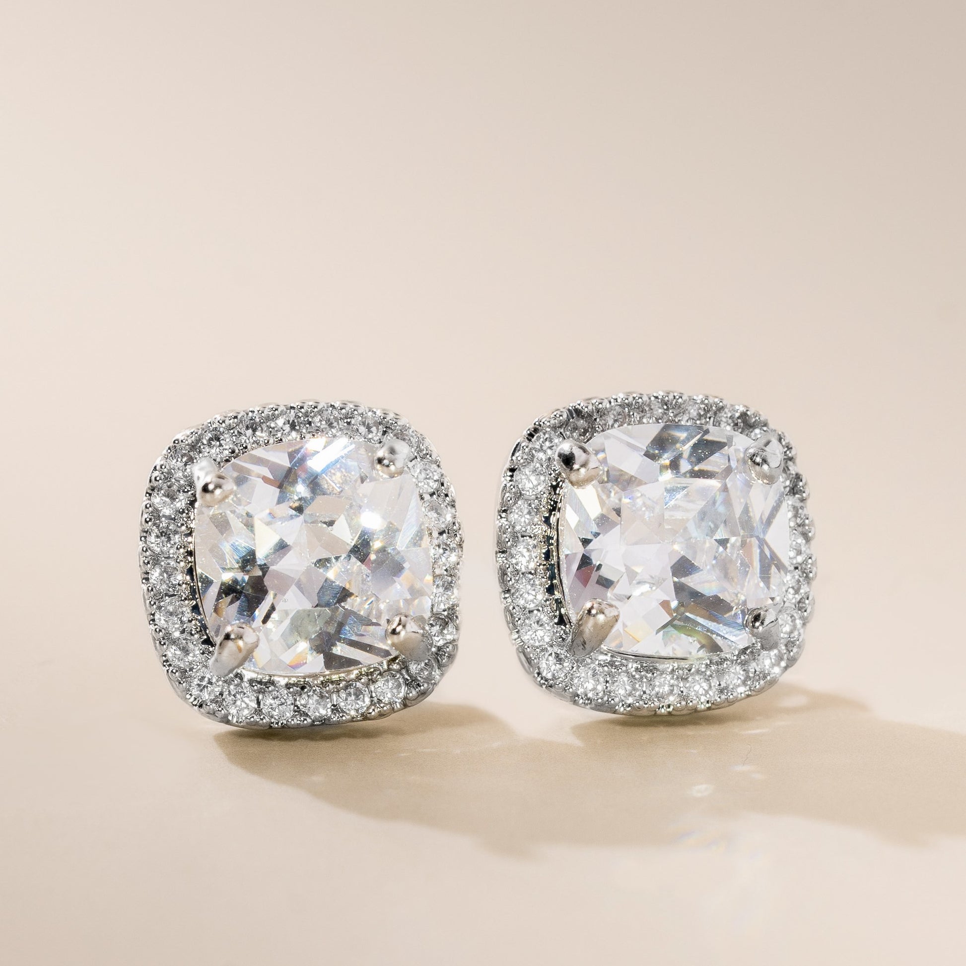 A pair of sterling silver cushion cubic zirconia stud earrings with a scattering of high-quality cubic zirconia stones.