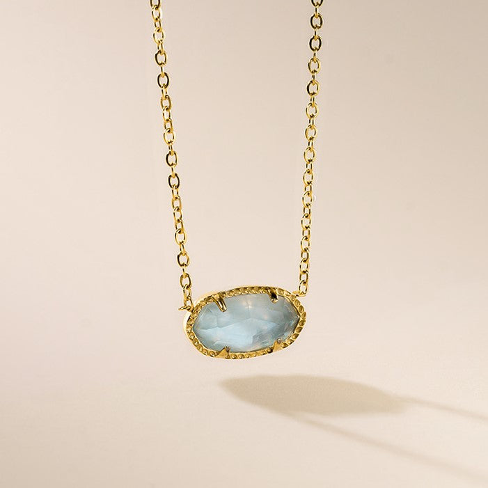 An 18 karat gold plated oval stone necklace with a chain and a lobster clasp closure.