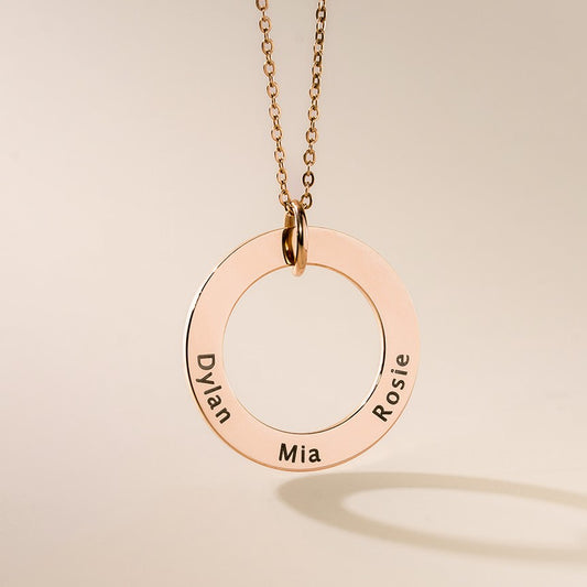 A rose gold washer pendants with names engraved