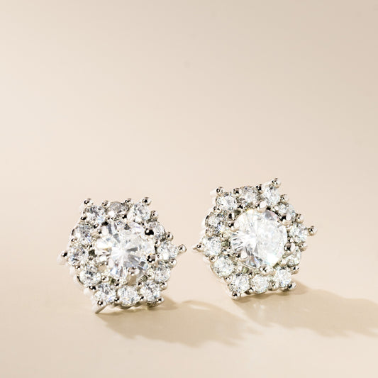A pair of silver hexagon cubic zirconia stud earrings with a sparkling design.
