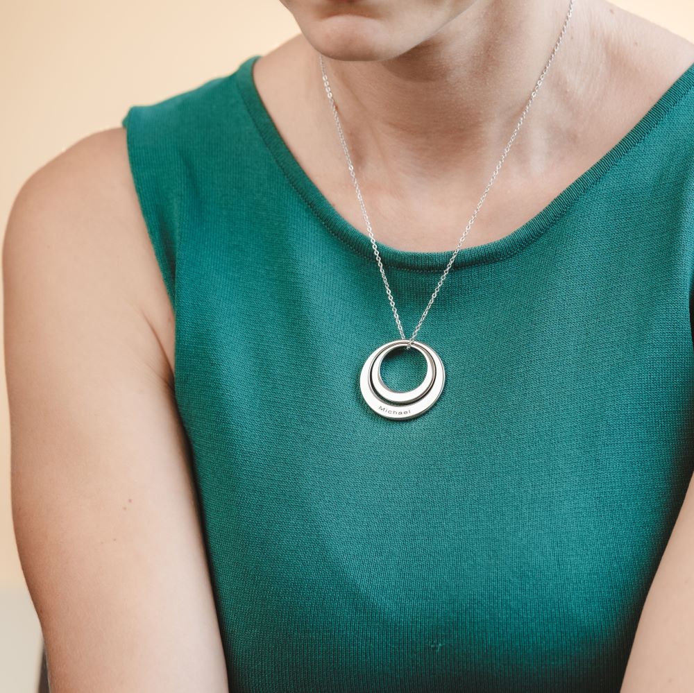 A woman wearing a large washer pendant necklace