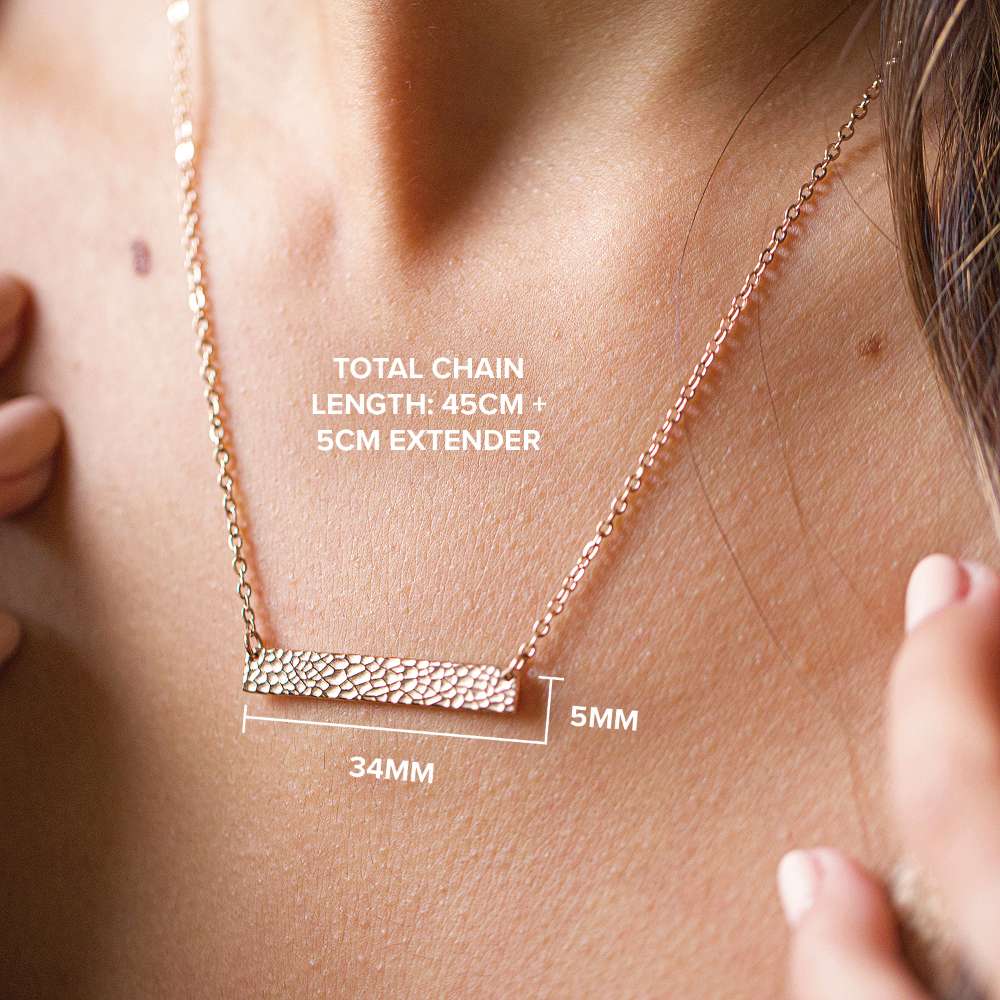 Necklace with measurement details on a person's neck