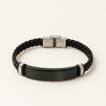 Black braided bracelet with a metallic clasp on a light background