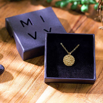 A box of gold hammered disc pendant necklace