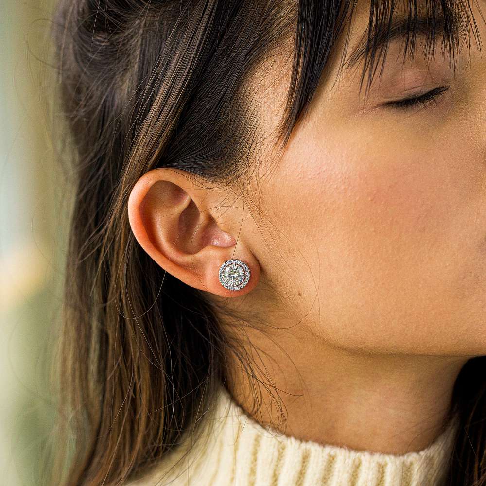 A girl wearing round cubic zirconia stud earrings