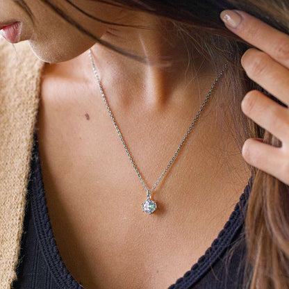 A girl wearing a cubic zirconia pendant necklace